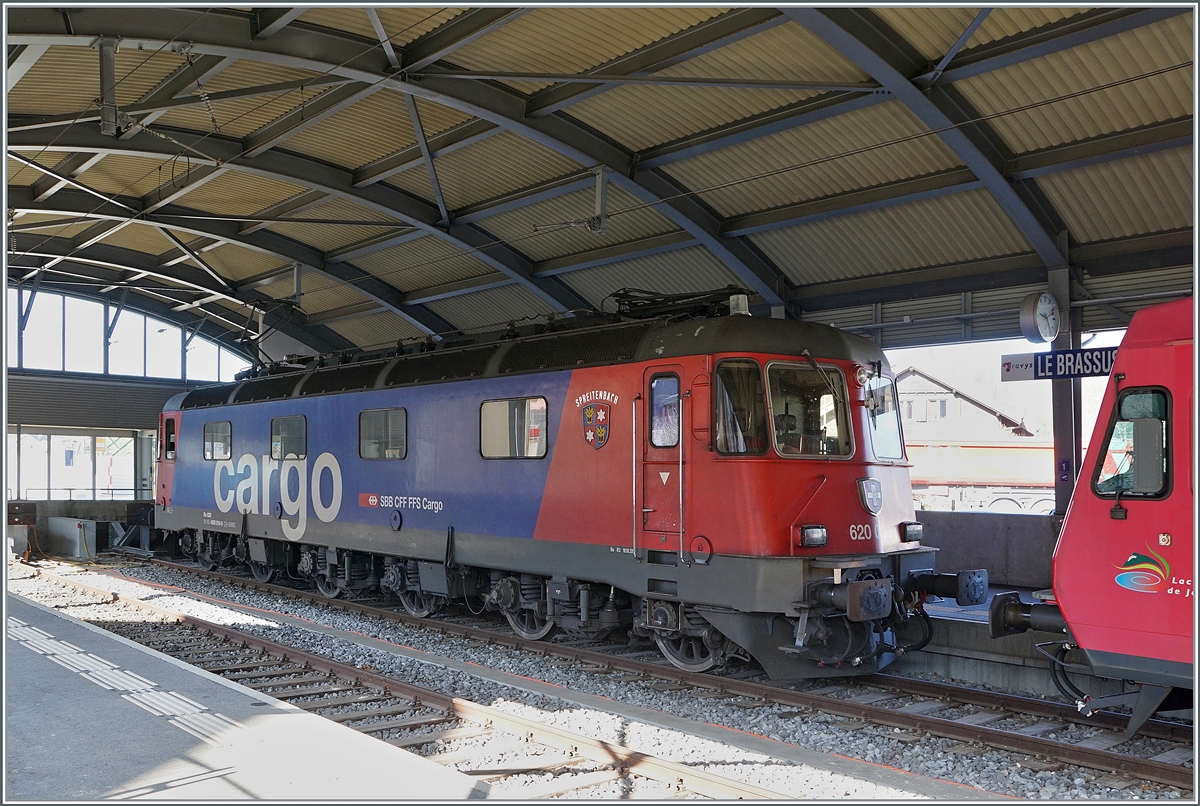 Auch wenn für wenige Monate die SBB Re 6/6 bis nach Le Brassus kommt, finde ich die Erscheinung der mächtigen Lok in diesem, kleinen Bahnhof nicht als alltäglich.  
Die SBB Re 6/6 11610 (Re 620 010-9)  Spreitenbach hat den aus Fans-u Wagen bestehenden Güterzug 69701 von Lausanne-Triage nach Le Brassus gebracht und wartet und im Bahnhof von le Brassus auf die Rückleistung am Nachmittag. 
24. März 2022 